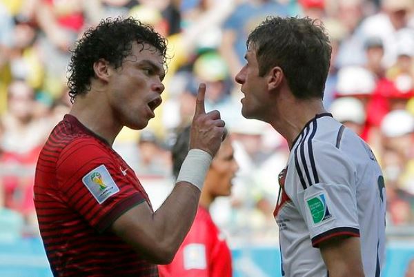 Portugal's Pepe, left, argues with Germany's Thomas Mueller after they clashed during the group G World Cup soccer match between Germany and Portugal at the Arena Fonte Nova in Salvador, Brazil, Monday, June 16, 2014.  (AP Photo/Matthias Schrader) Brazil Soccer WCup Germany Portugal